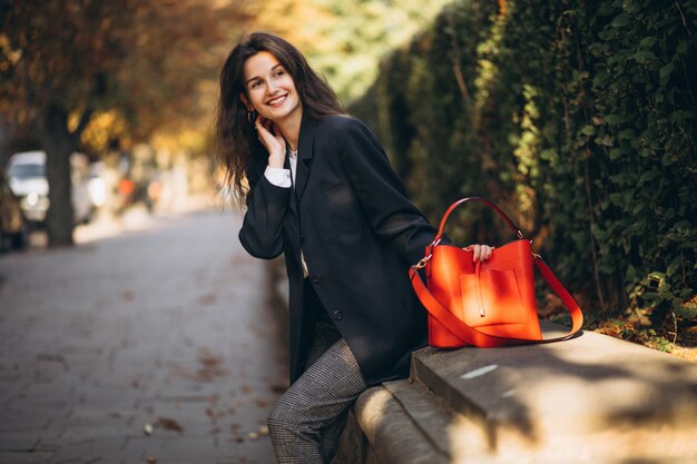 young business lady sitting in park