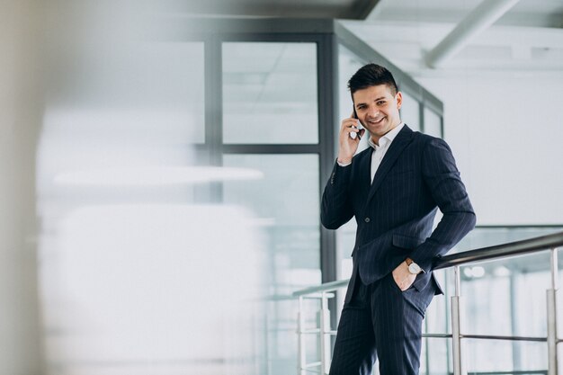 Young business man talking on phone in the office