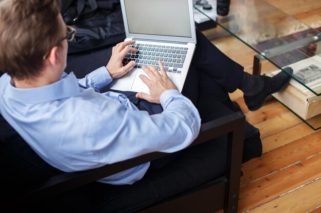 Young business man working with laptop in office.