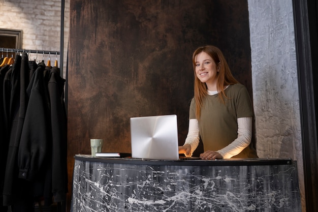 Free photo young business owner preparing her store