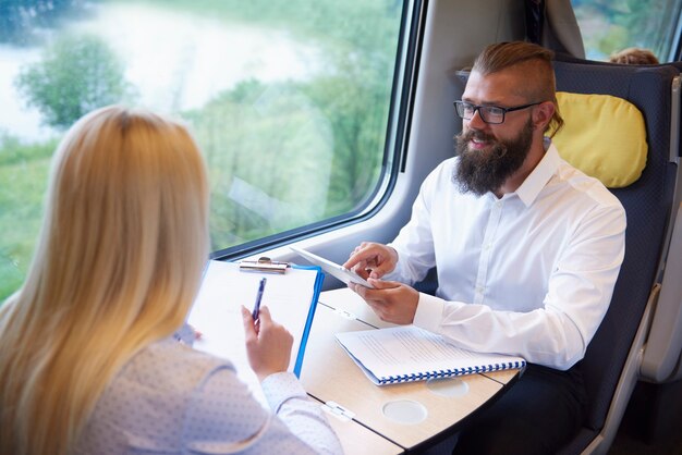 Young business people working in the train