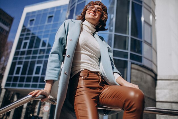 Young business woman in casual outfit by the business center