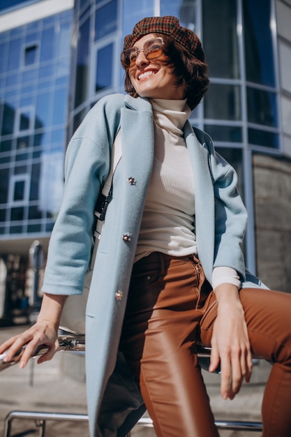 Young business woman in casual outfit by the business center