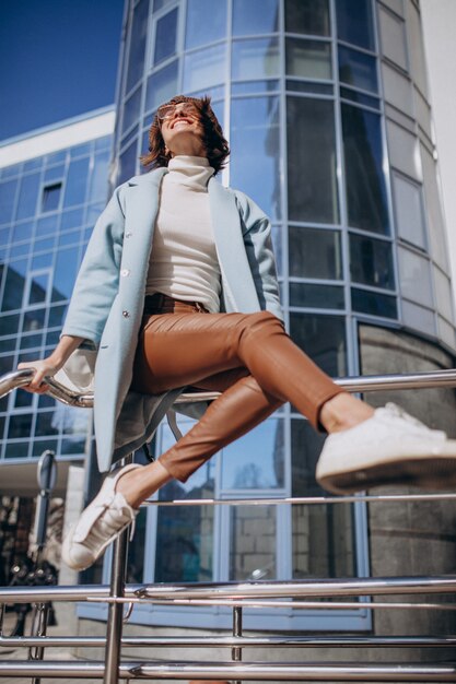 Young business woman in casual outfit by the business center