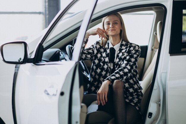 Young business woman choosing a car