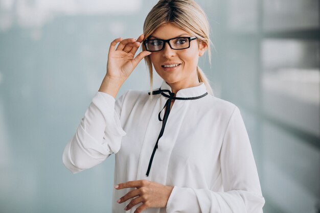 Young business woman in classy outfit in office