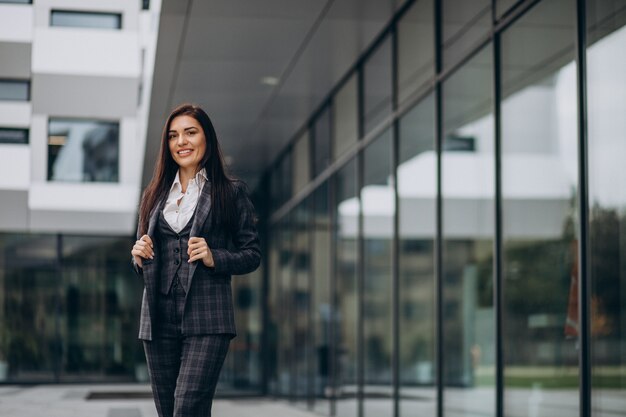 Young business woman in classy suit by office center