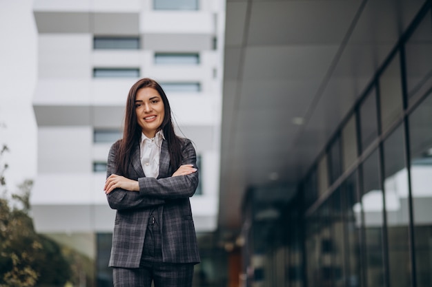 Young business woman in classy suit by office center