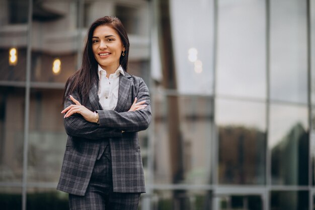 Young business woman in classy suit by office center