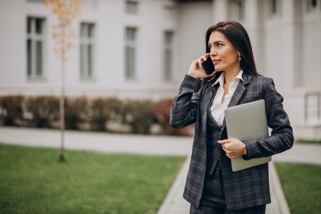 Young business woman in classy suit by office center