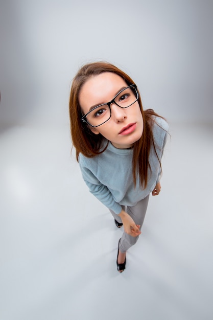 The young business woman on gray background