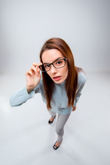 The young business woman on gray wall