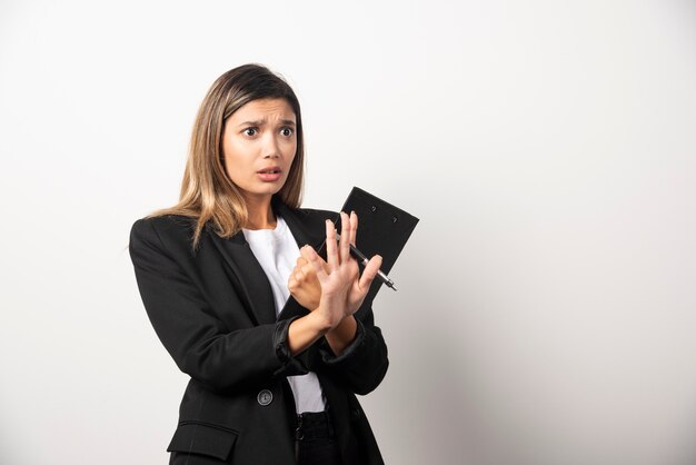 Young business woman holding clipboard .