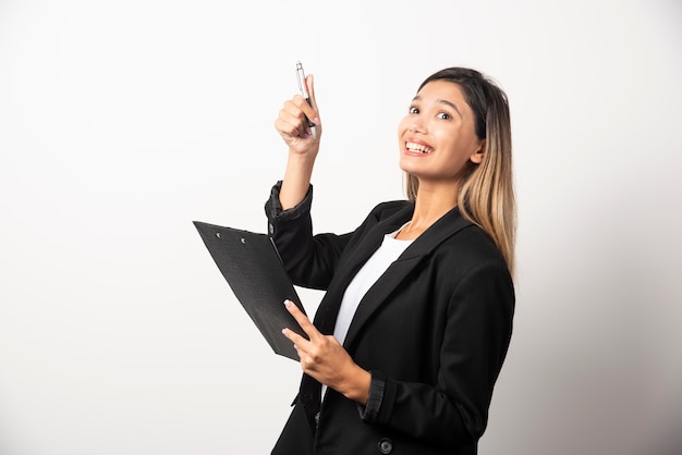 Young business woman holding clipboard . 