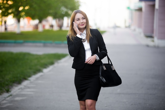 Young business woman on mobile phone