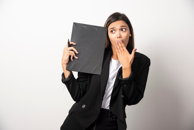 Young business woman showing clipboard .