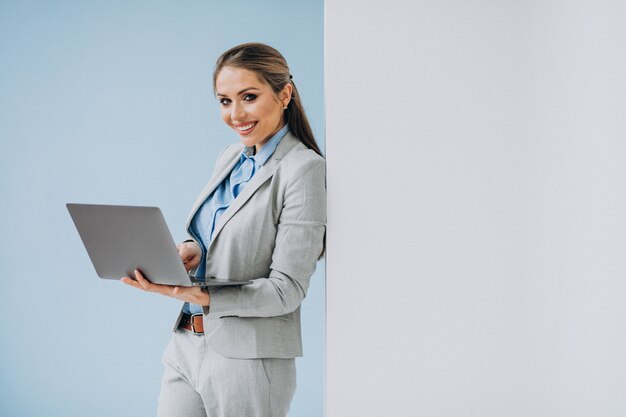 Young business woman standing in the office isolated