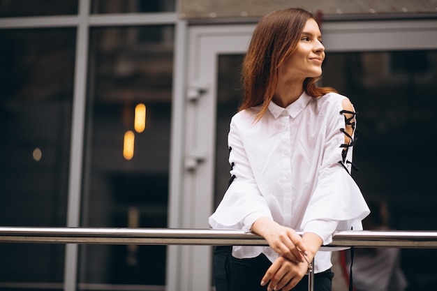 Young business woman standing outside office center