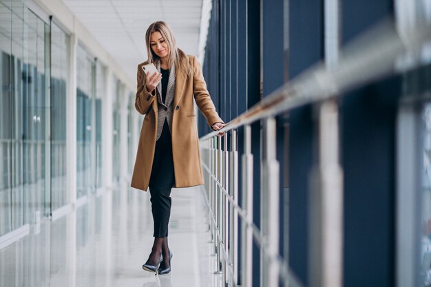 Young business woman talking on the phone in an airport