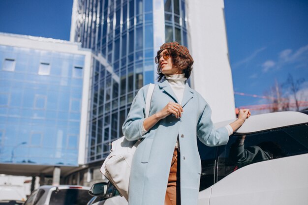 Young business woman travelling by electro car