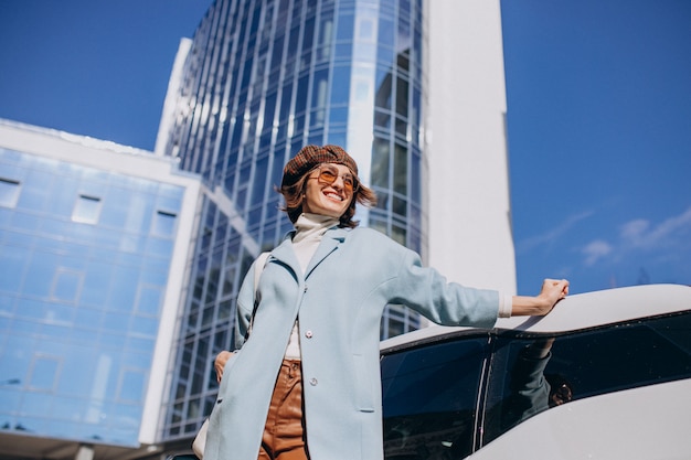 Free photo young business woman travelling by electro car