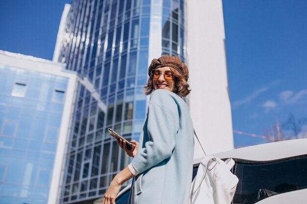 Young business woman travelling by electro car