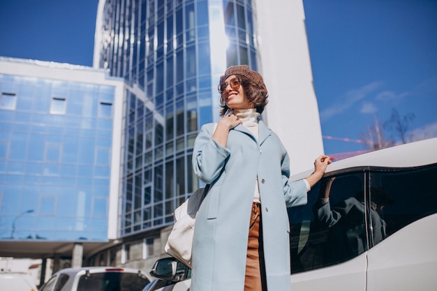 Free photo young business woman travelling by electro car