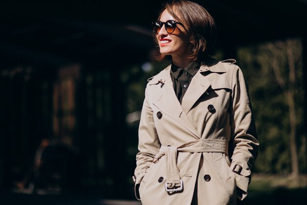 Young business woman in a trendy coat outside
