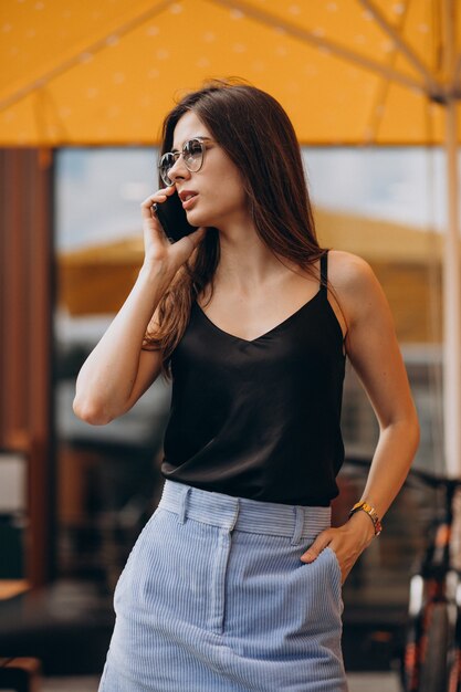 Young business woman using phone on a vacation