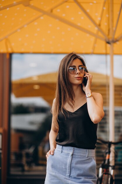 Young business woman using phone on a vacation