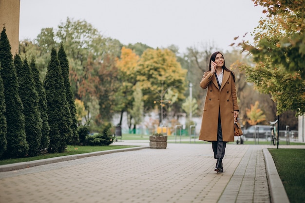 Free photo young business woman using phone