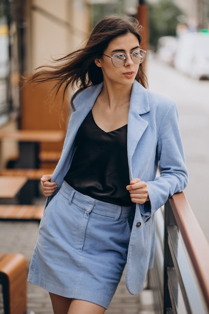 Young business woman walking down the stairs