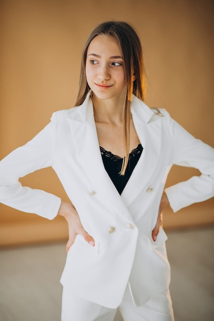 Free photo young business woman in white suit at the studio