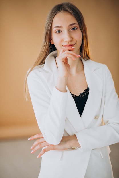Young business woman in white suit at the studio