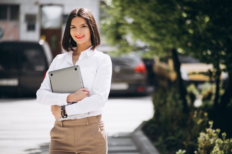 Free Photo young business woman with laptop outside the street