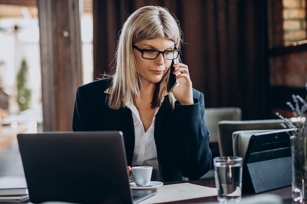 Young business woman working on computer in a cafe