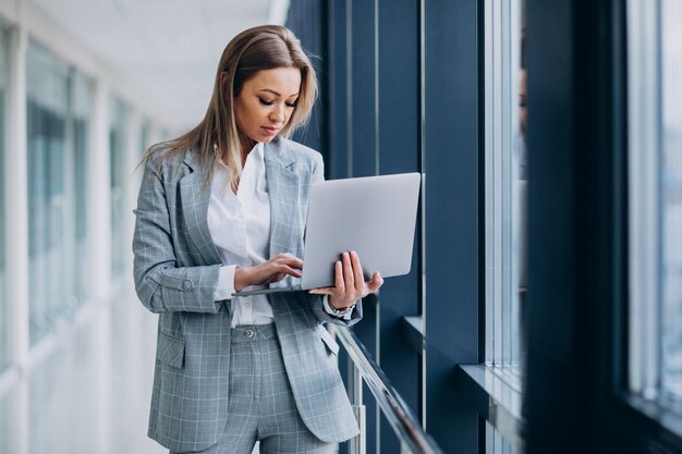 Young business woman working on laptop in a computer