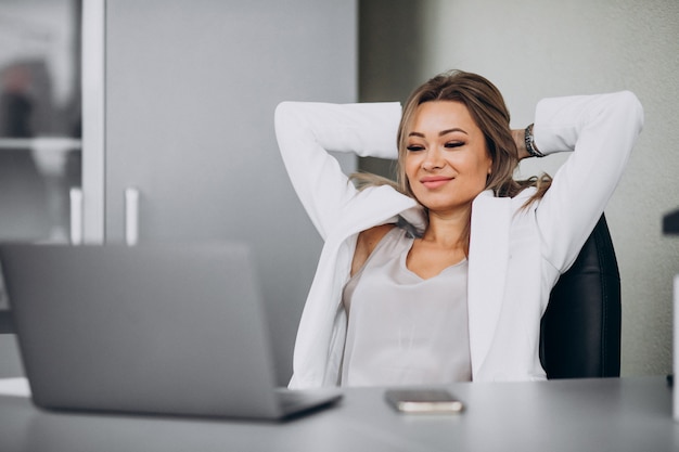 Young business woman working on laptop in an office