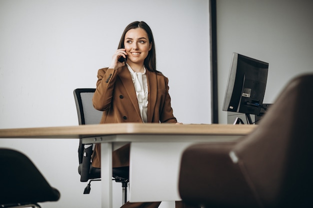 Young business woman working on laptop in office