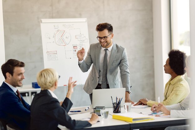 Young businessman communicating with his colleagues during a meeting in the office