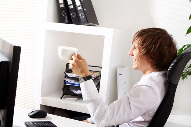 Young businessman drinking coffee at morning time