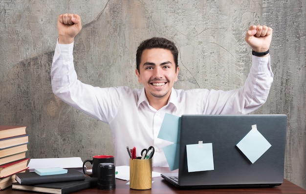 Free photo young businessman having best moments at the office desk.