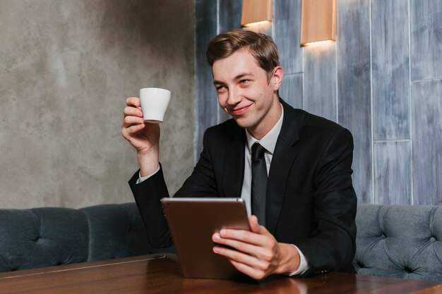 Young businessman holding tablet