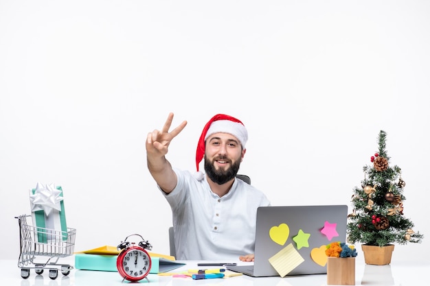 Young businessman in office celebrating and showing two