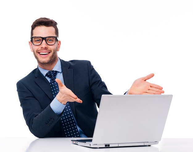 Young businessman points at the computer