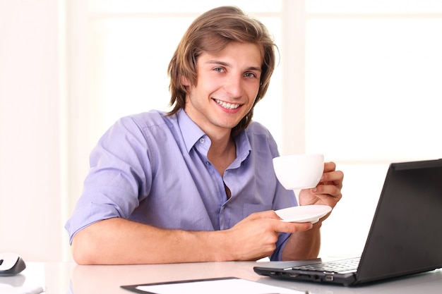 Young businessman taking a break with cup of coffee