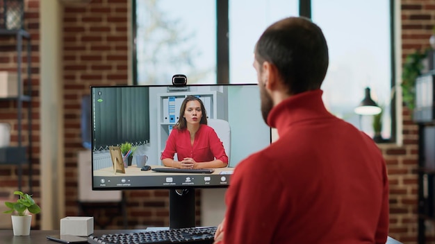 Young businessman talking to manager on remote teleconference, using online conference meeting on computer. manager chatting with woman on videocall connection. telecommunication.