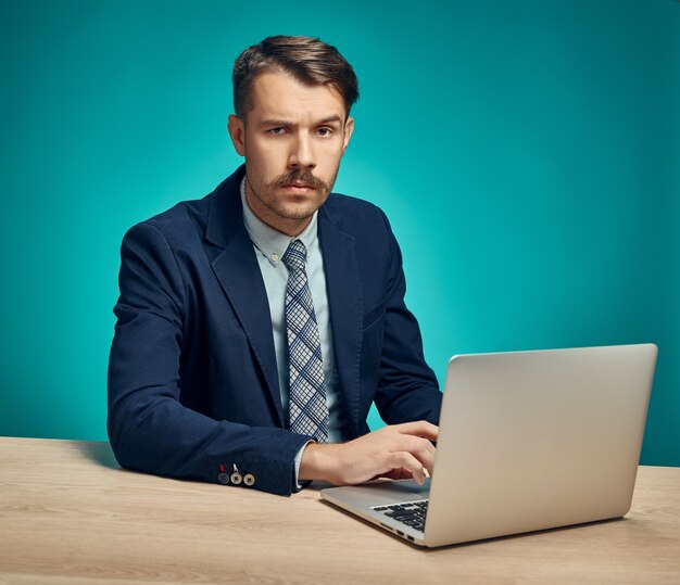 Young businessman using computer at the office