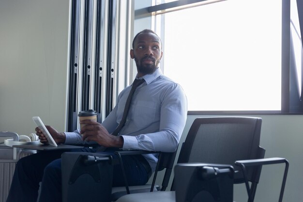 Young businessman waiting for departure in airport