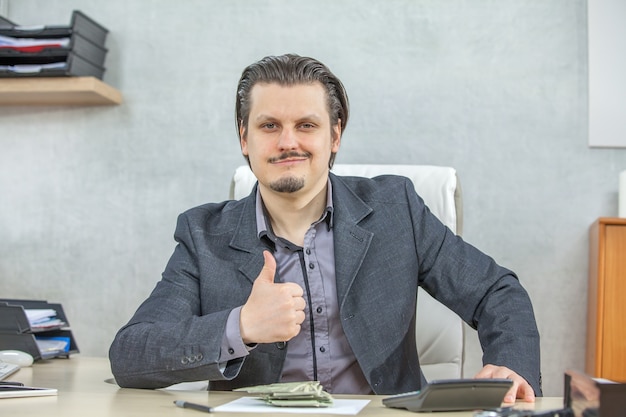 Young businessman working from his office  - the concept of confidence and success